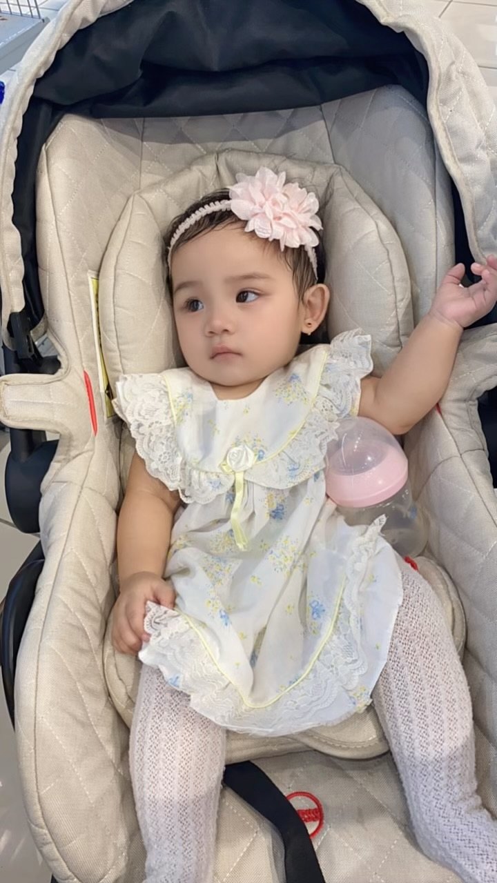 Ciara in a floral outfit sitting in a stroller